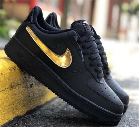 gold and black Nike shoes